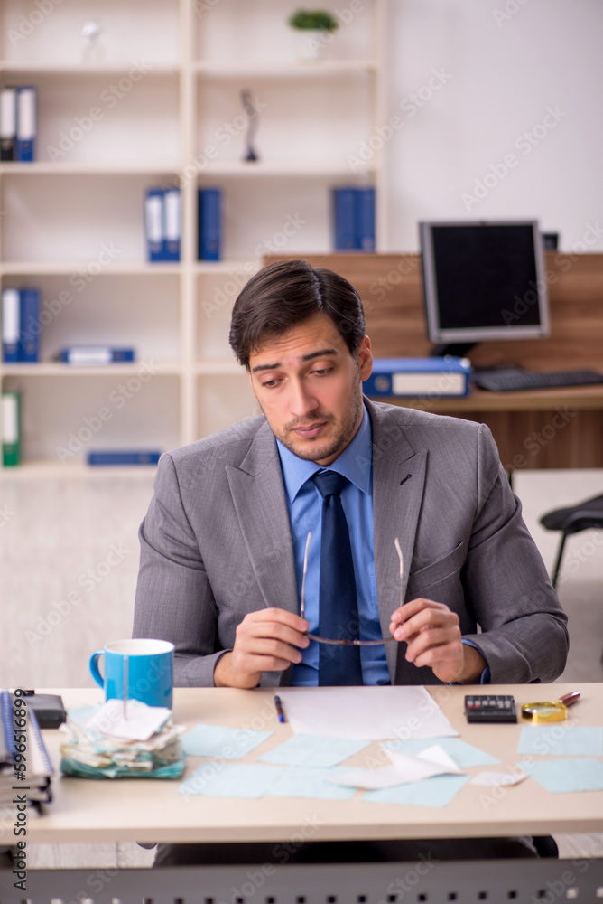 Young male accountant working in the office Young male accountant working in the office