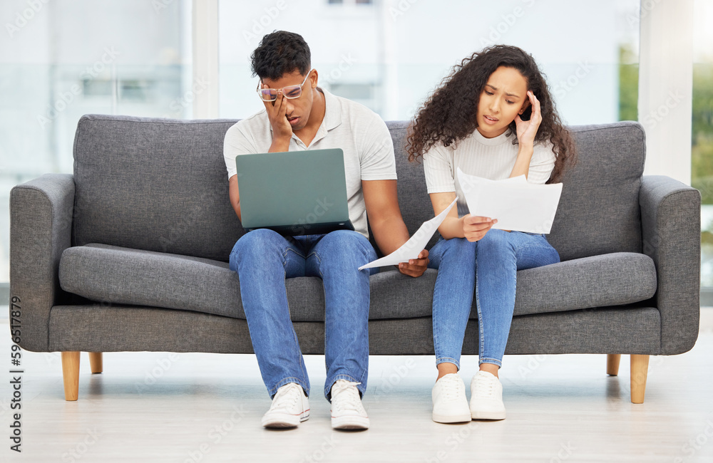 Can we unsubscribe from being adults. Shot of a young couple using a laptop while going through paperwork at home.