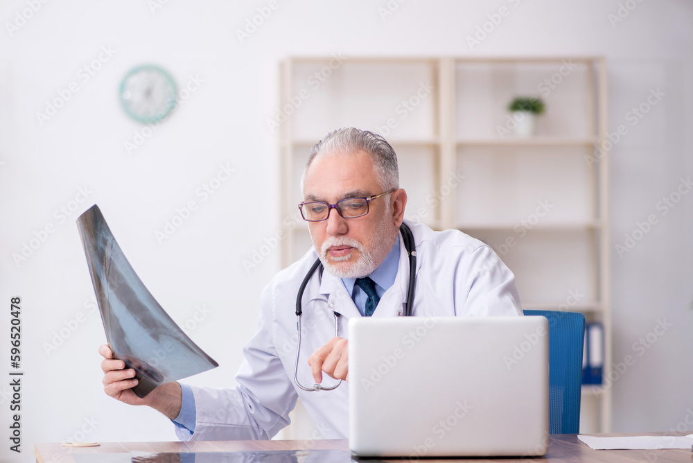Old male doctor radiologist working in the clinic Old male doctor radiologist working in the clinic