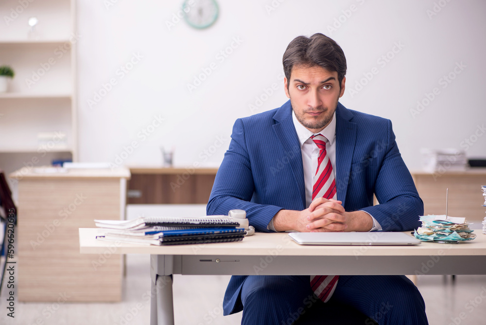 Young male employee working in the office Young male employee working in the office