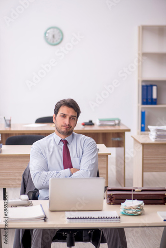 Young male employee working in the office