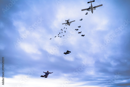Skydive formation with two airplanes and clouds