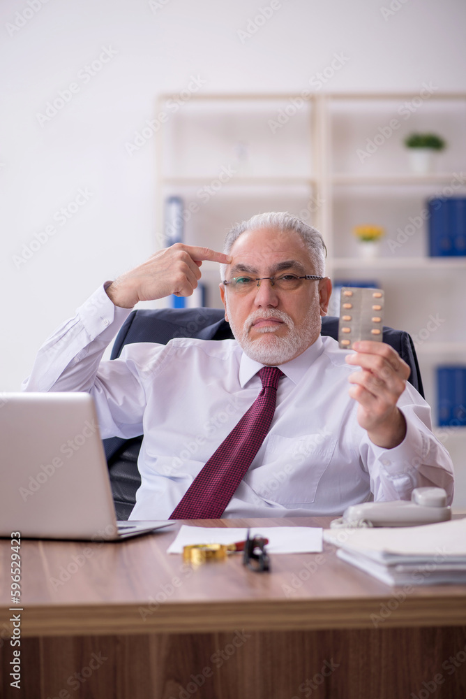 Old male employee feeling bad in the office Old male employee feeling bad in the office
