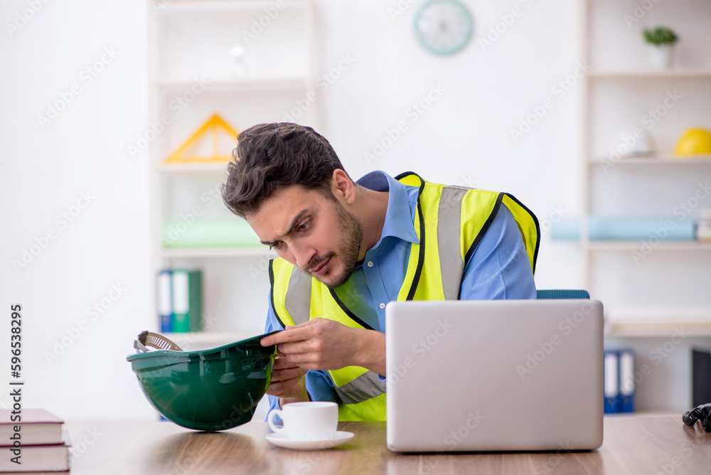 Young male architect working in the office Young male architect working in the office