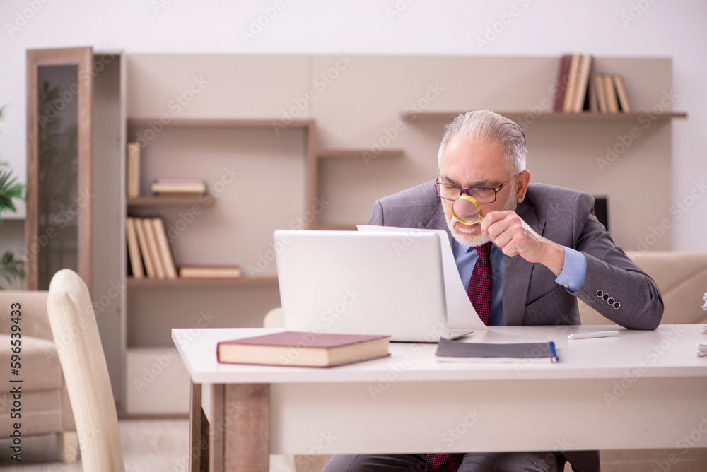 Fototapeta premium Old male employee working from home during pandemic
