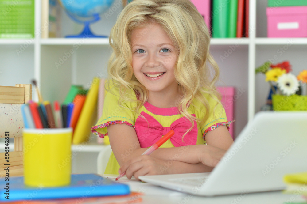 girl using laptop at desk at home girl using laptop at desk at home