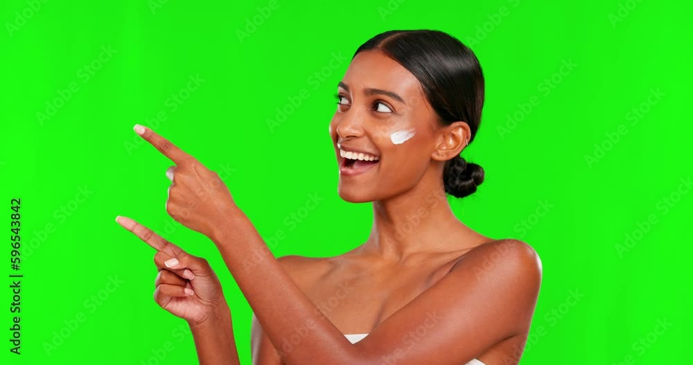 Beauty, lotion and a woman pointing on a green screen background in studio for natural skincare. Portrait, cream or antiaging treatment with a happy young female model advertising on chromakey mockup Beauty, lotion and a woman pointing on a green screen background in studio for natural skincare. Portrait, cream or antiaging treatment with a happy young female model advertising on chromakey mockup
