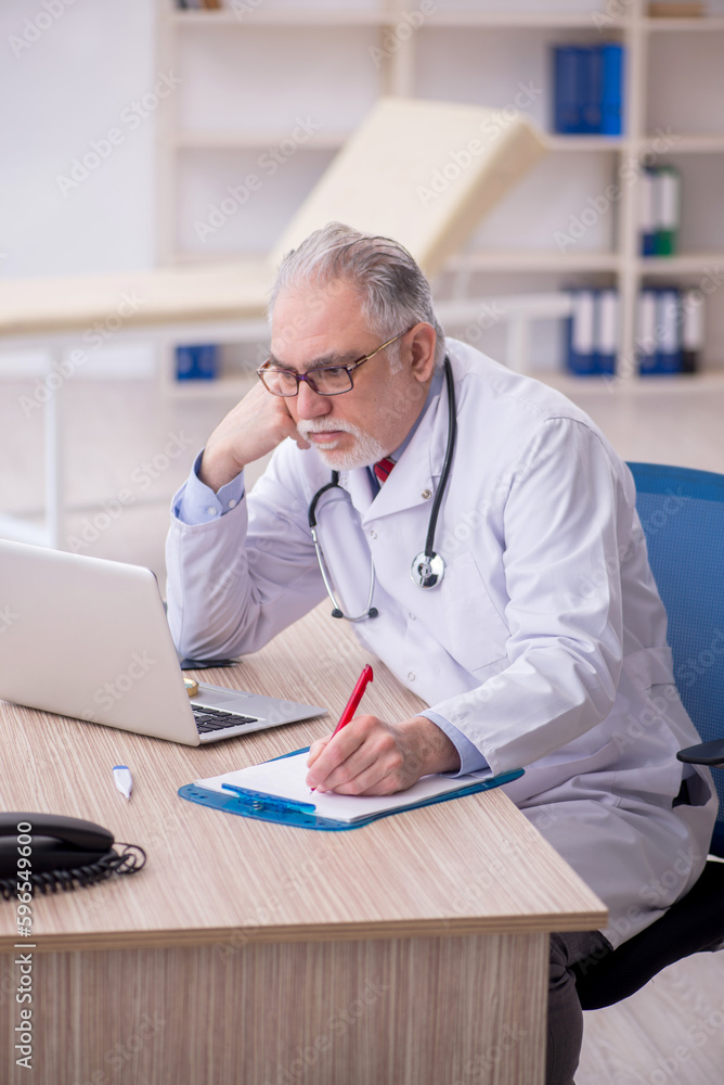 Old male doctor in telemedicine concept Old male doctor in telemedicine concept