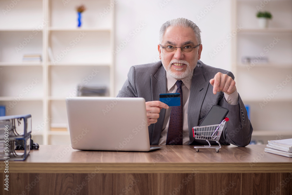 Old male employee in e-commerce concept Old male employee in e-commerce concept