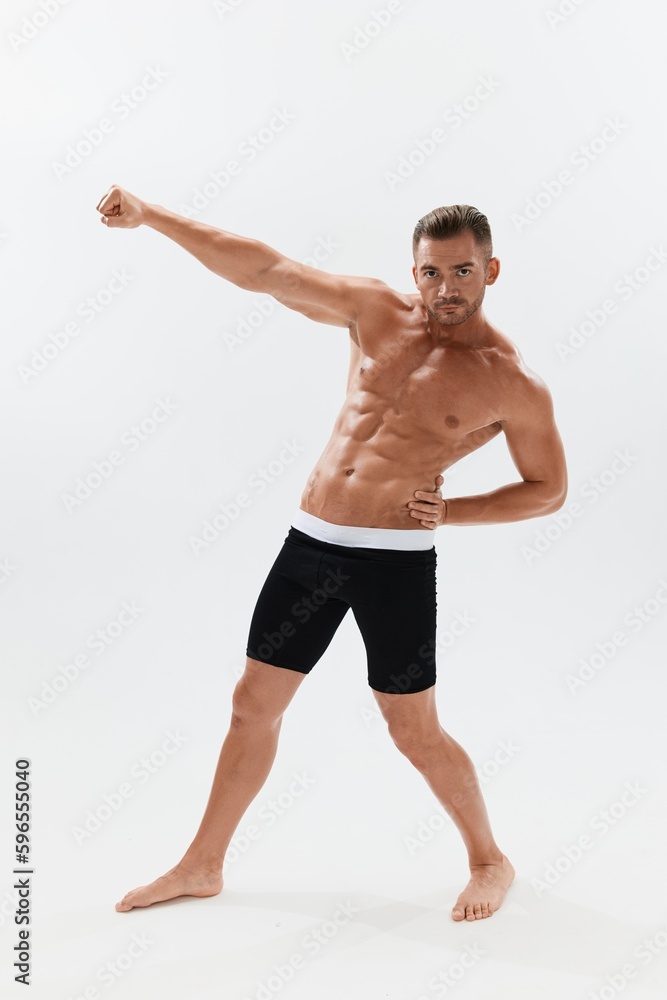 Man athletic body bodybuilder in briefs with naked torso abs full-length in the background, fitness classes. Advertising, sports, active lifestyle, competition, challenge concept. Man athletic body bodybuilder in briefs with naked torso abs full-length in the background, fitness classes. Advertising, sports, active lifestyle, competition, challenge concept.