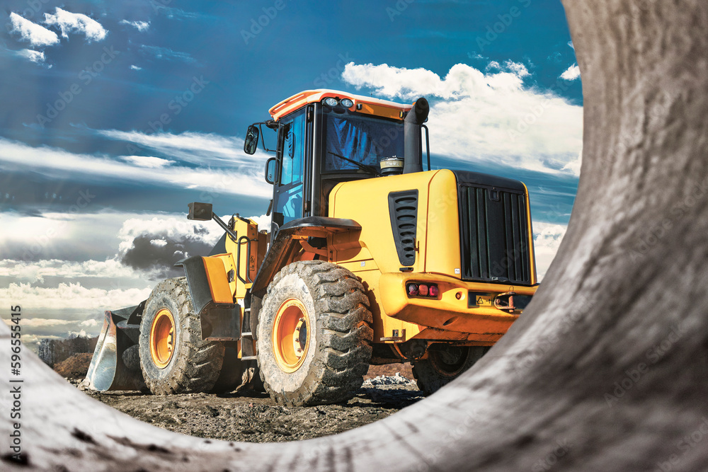 Powerful wheel loader or bulldozer working on a quarry or construction site. Earthworks in construction. Powerful modern equipment for earthworks. Powerful wheel loader or bulldozer working on a quarry or construction site. Earthworks in construction. Powerful modern equipment for earthworks.