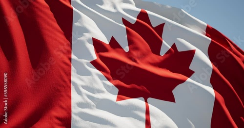 Close-up of the national flag of Canada flutters in the wind on a sunny day , 4k slow motion