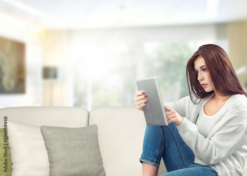 Happy young woman surfing internet on digital tablet Happy young woman surfing internet on digital tablet