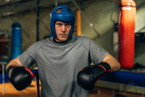 A serious man fighter is standing in the corner of the ring © cherryandbees