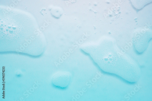 Abstract white soap foam bubbles texture on blue background