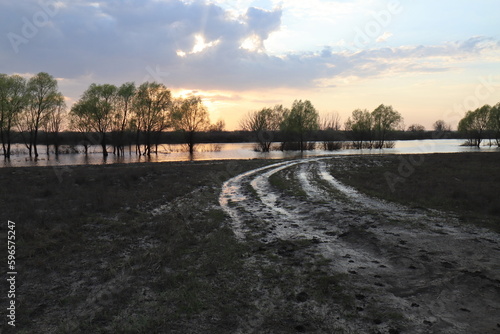 Reflection of a golden sunset in the water mirror in the Staritsa River