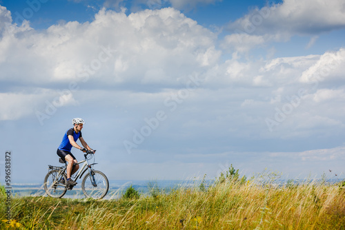 Cyclist Riding the Bike on the Beautiful Spring Mountain Trail © olyphotostories