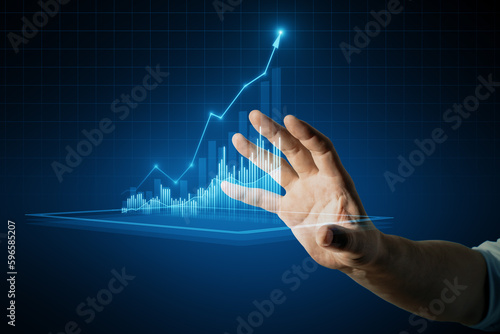 Close up of male hand holding growing business chart on blurry background. Business strategy development, financial growth and success plan.