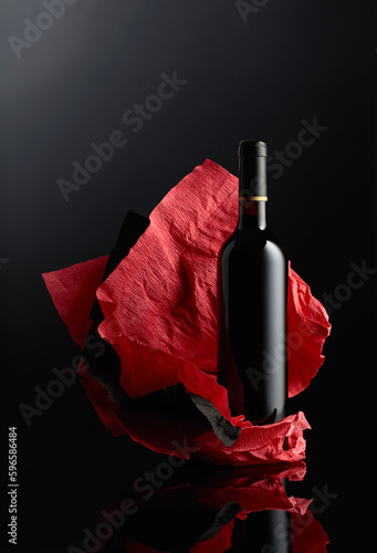 Bottle of red wine on a crumpled paper.