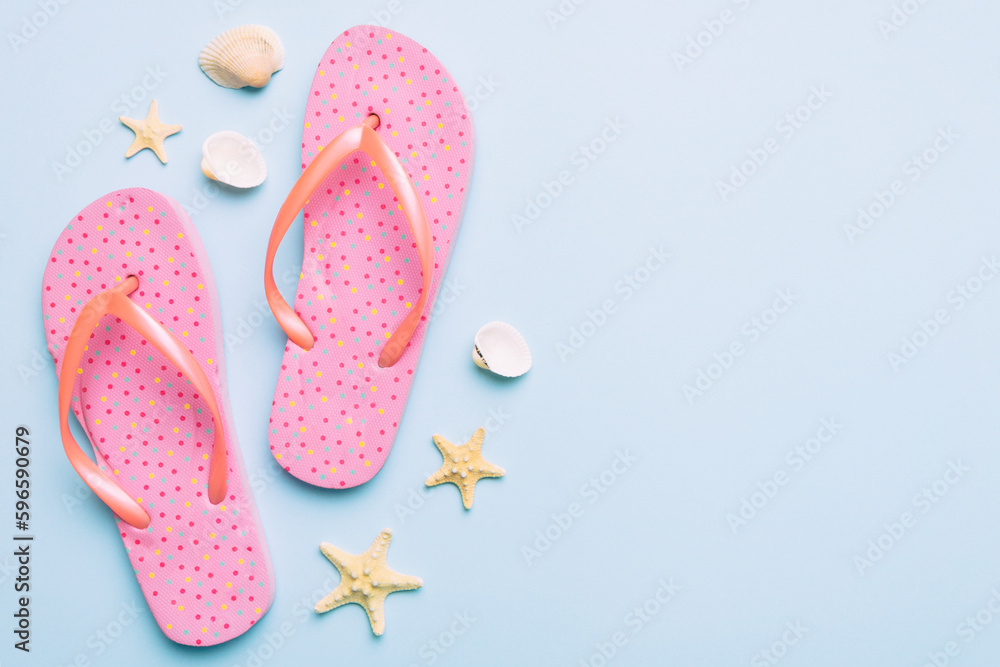 Flat lay composition with flip flops and seashell on colored background. Space for text top view Flat lay composition with flip flops and seashell on colored background. Space for text top view