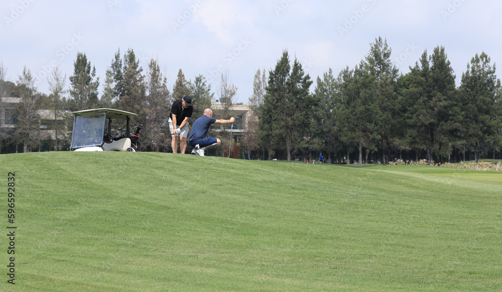 man playing golf on a green field man playing golf on a green field