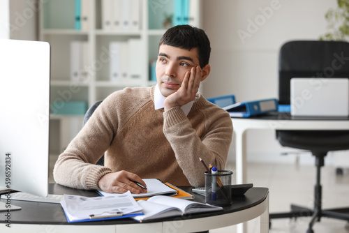 Young accountant sitting at...