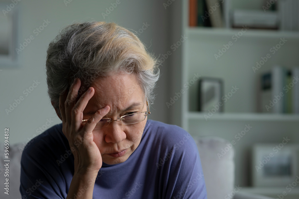 Portrait of sad and lonely Asian senior woman in living room Portrait of sad and lonely Asian senior woman in living room