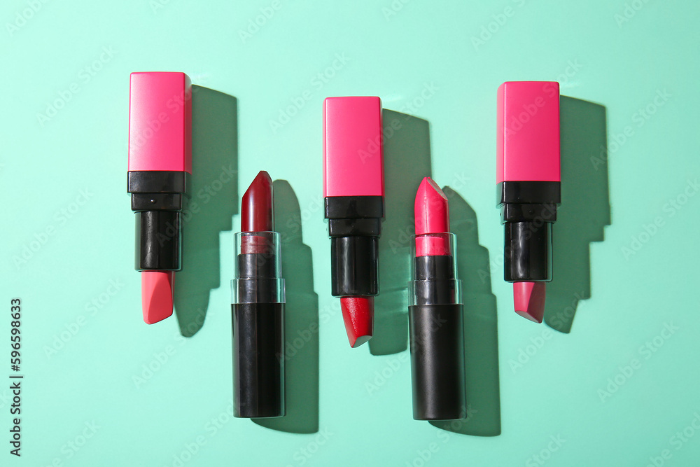 Composition with beautiful lipsticks on turquoise background Composition with beautiful lipsticks on turquoise background