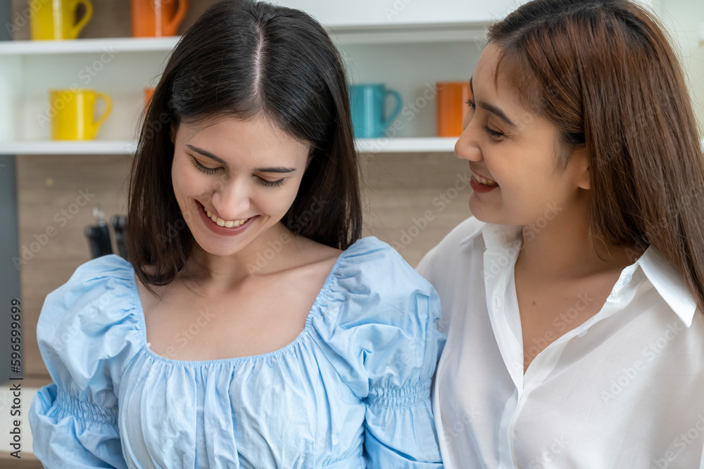 Young beautiful LGBT woman and girlfriend eating breakfast in kitchen Young beautiful LGBT woman and girlfriend eating breakfast in kitchen