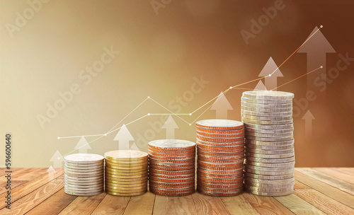 Stacked coins and profit charts show a good investment for the future.