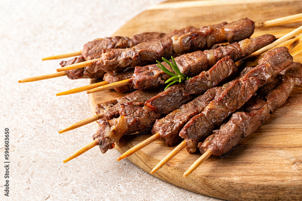  Italian lamb skewers or kebabs cooked on a brazier, with rosemary and spices.  Arrosticini. - obrazy, fototapety, plakaty 