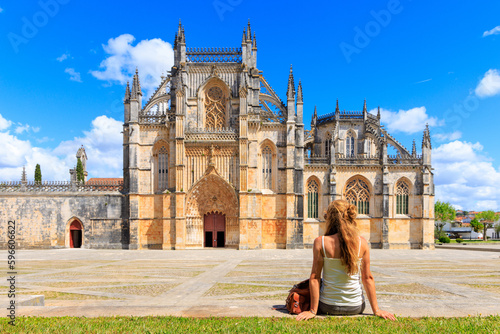 Woman tourist traveling in Portugal- Batalha Monastery- Gothic style photo
