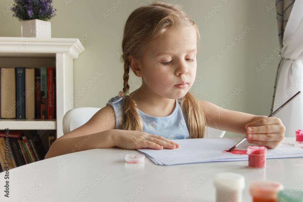 Little child draws with watercolor, concept of education in the kindergarten Little child draws with watercolor, concept of education in the kindergarten