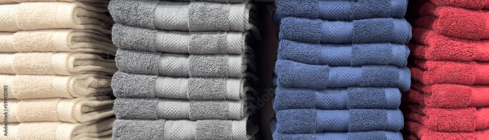 Stack of colorful towels. Fresh new fluffy towels. Pile stacked colored fabric towels. Stack colored cotton towels.