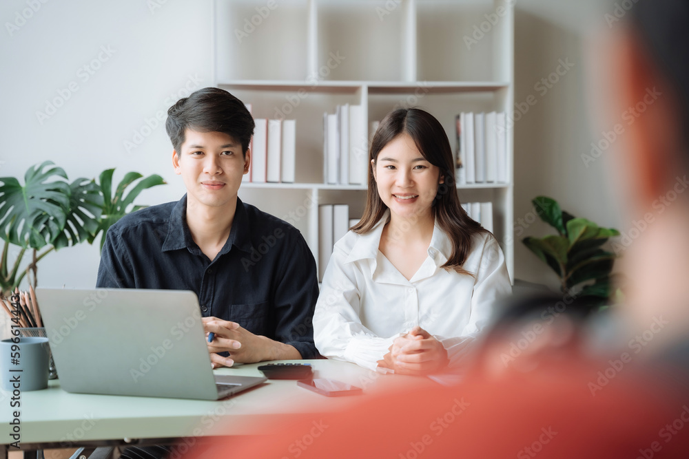 Photo of a cute cheerful young couple, looking at the camera. Photo of a cute cheerful young couple, looking at the camera.