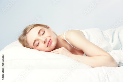 Young beautiful girl sleeps in the bedroom.