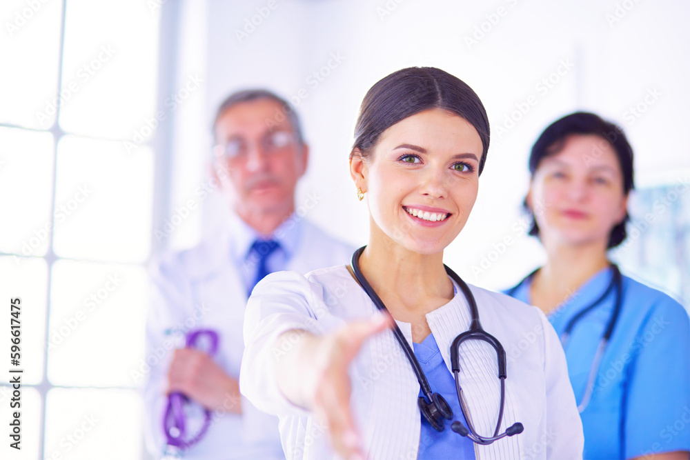 Doctor offering a handshake in the hospital Doctor offering a handshake in the hospital