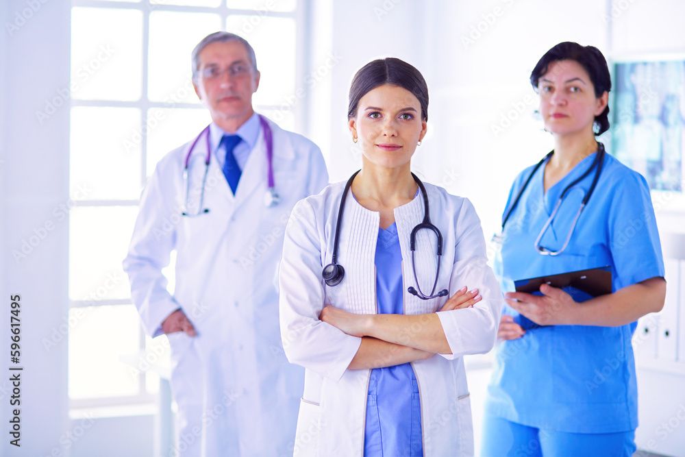 Group of doctors and nurses standing in the hospital room Group of doctors and nurses standing in the hospital room