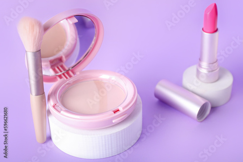 Decorative plaster podiums and cosmetics on lilac background © Pixel-Shot