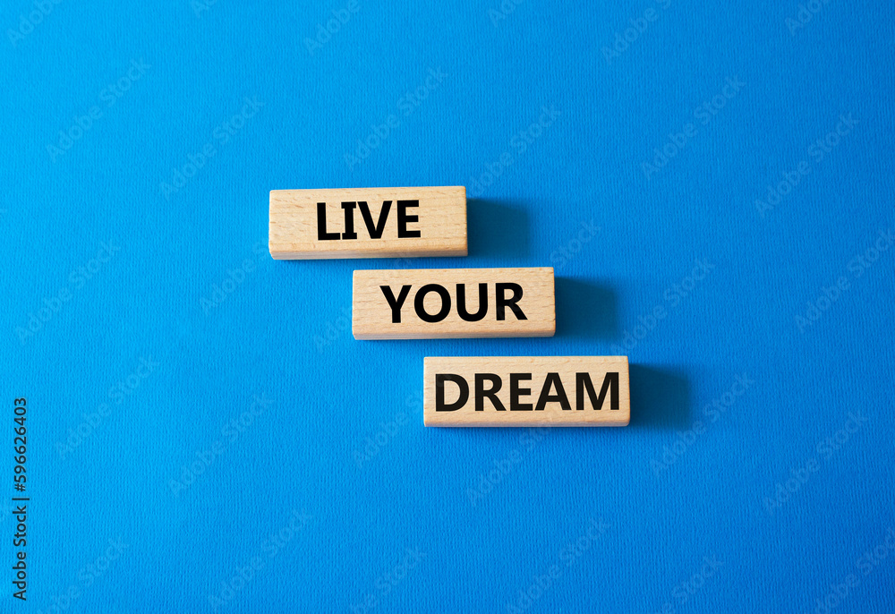 Live your Dream symbol. Wooden blocks with words Live your Dream. Beautiful blue background. Business and Live your Dream concept. Copy space.