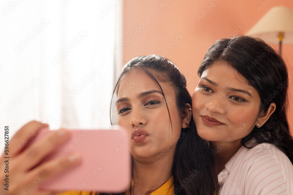 Close-up portrait of two young women taking selfie together
