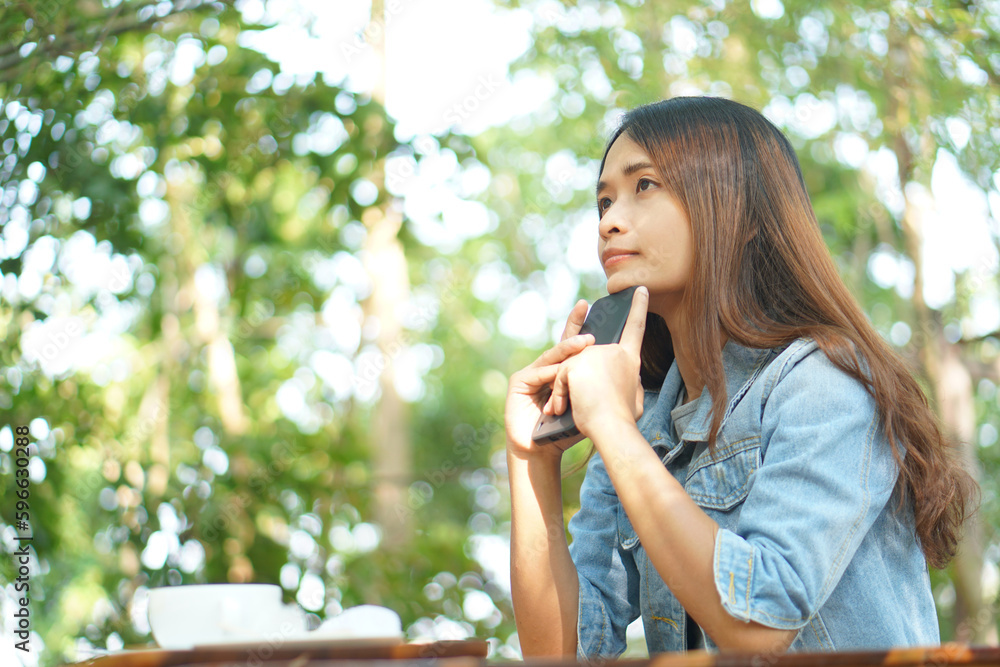 Woman thinking hard as profits decline in coffee cafe Woman thinking hard as profits decline in coffee cafe