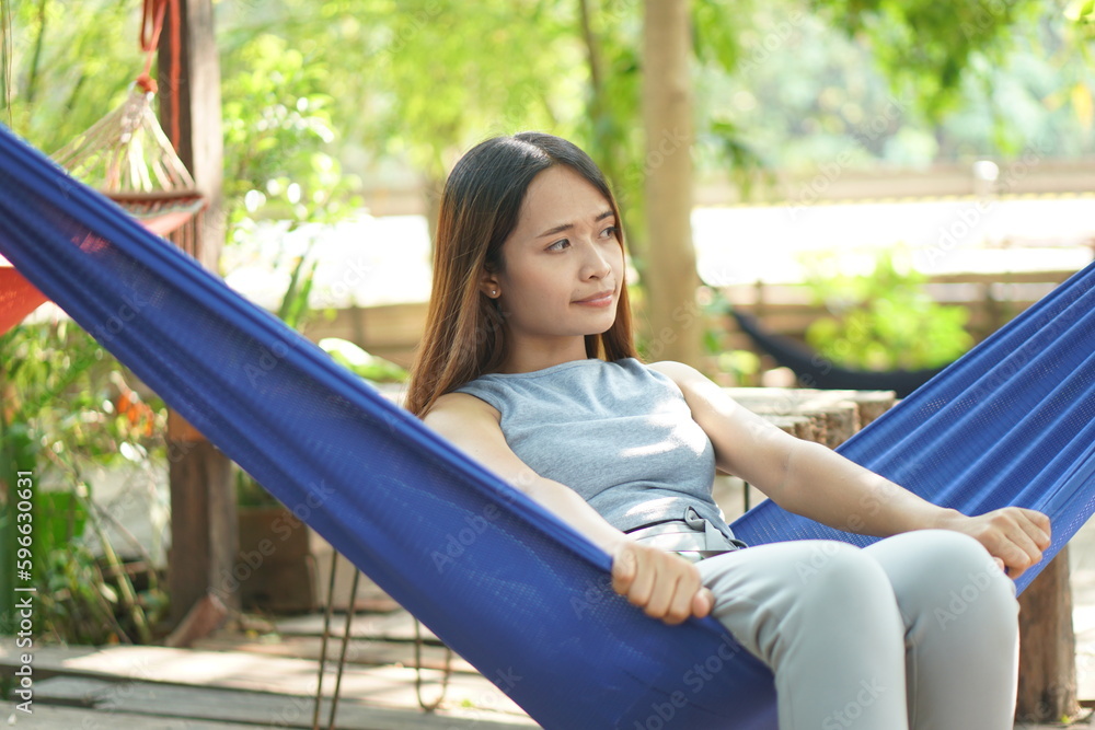 Woman sitting in a hammock in a coffee shop Woman sitting in a hammock in a coffee shop