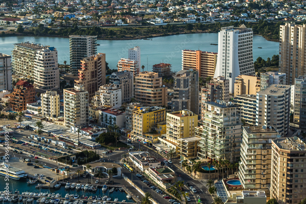 Naklejka premium modern apartments, Cantal Roig beach and sailboats and fishing boats in the port of Calpe. Top view, horizontal
