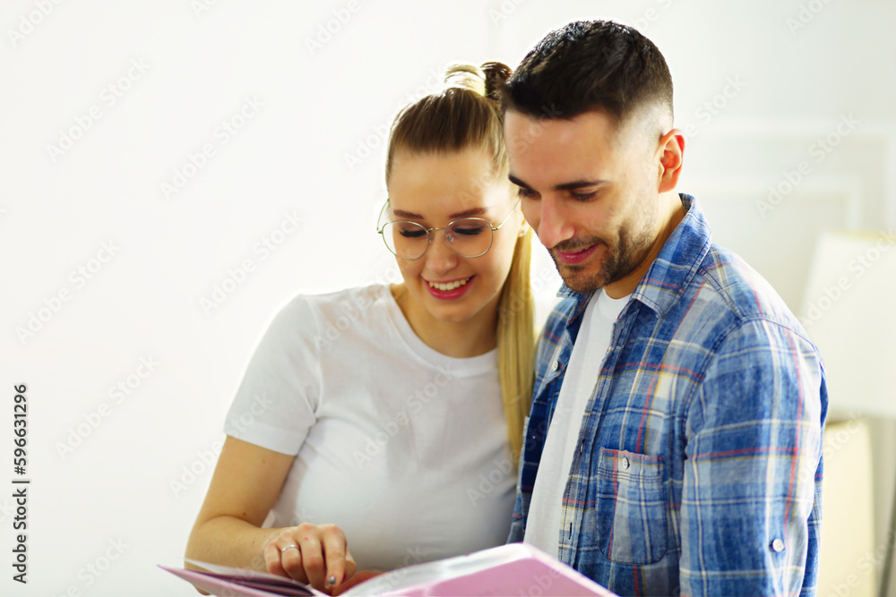 A just married couple unpacking boxes and moving into a new home. Positive emotion. A just married couple unpacking boxes and moving into a new home. Positive emotion.