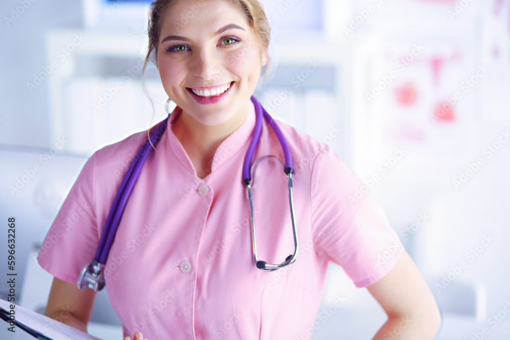 Woman doctor standing with folder at hospital. Woman doctor standing with folder at hospital.