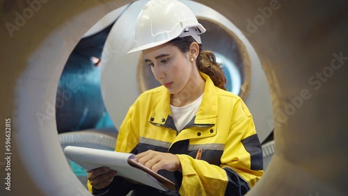 Εκτύπωση καμβά Hispanic latina woman engineer holding clipboard seen through a large pipe steel