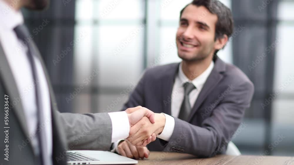 Portrait of cheerful young manager handshake with new employee. Portrait of cheerful young manager handshake with new employee.