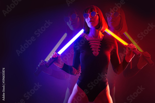 Neon close up portrait of young woman portrait in RGB color split. Red sunglasses with glow sticks.