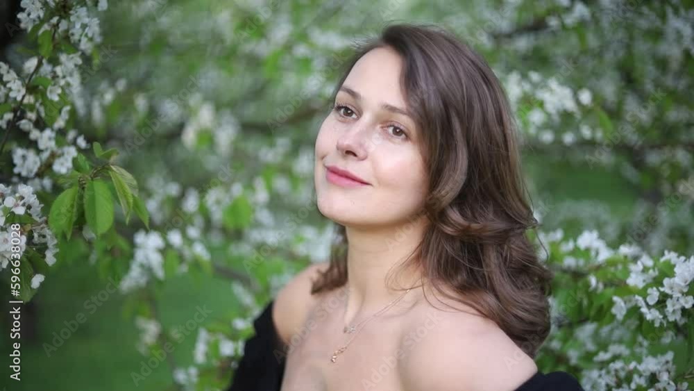 beautiful woman and blossoming tree in spring posing beautiful woman and blossoming tree in spring posing
